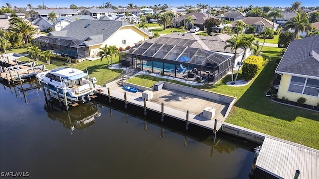 dock area featuring a lanai, a residential view, and a lawn