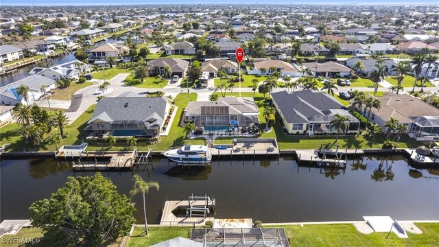 birds eye view of property with a residential view and a water view