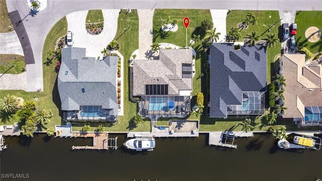 drone / aerial view featuring a water view and a residential view