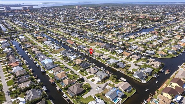 drone / aerial view featuring a residential view and a water view