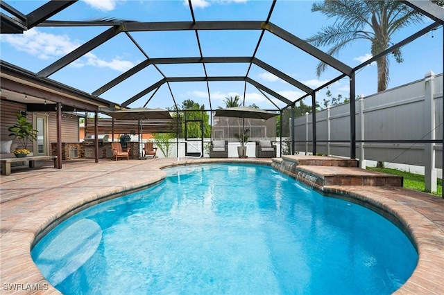 outdoor pool with glass enclosure and a patio area