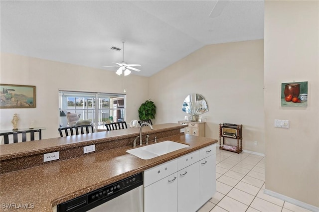 kitchen with ceiling fan, light tile patterned flooring, a sink, dishwasher, and dark countertops