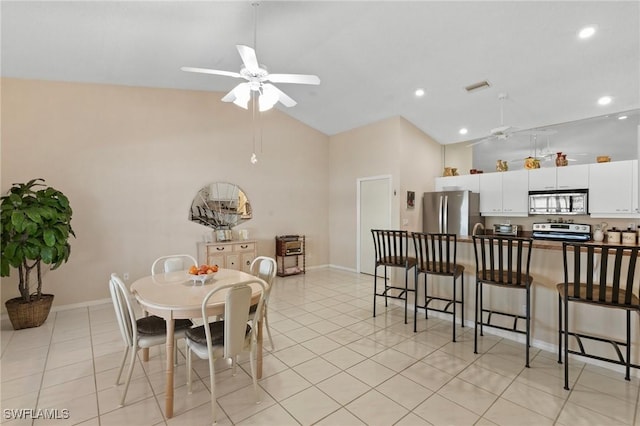 dining area featuring light tile patterned floors, high vaulted ceiling, visible vents, baseboards, and a ceiling fan