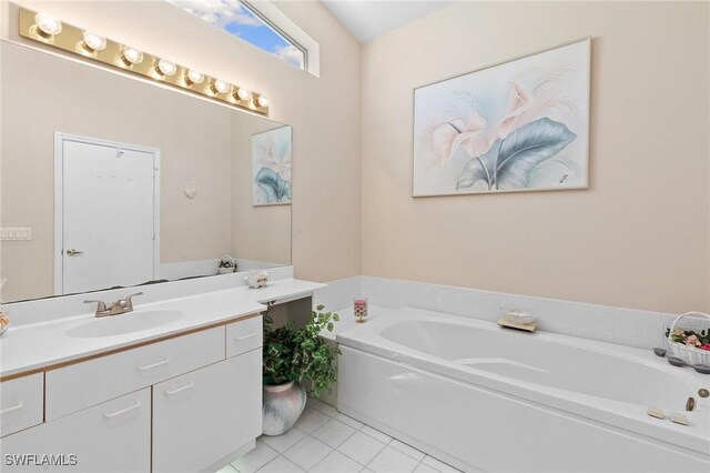 full bath featuring a bath, vanity, and tile patterned floors