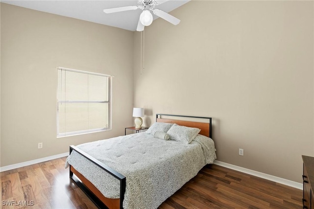 bedroom featuring wood finished floors, a ceiling fan, and baseboards