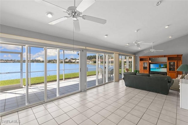 unfurnished living room featuring lofted ceiling, a water view, recessed lighting, and light tile patterned flooring