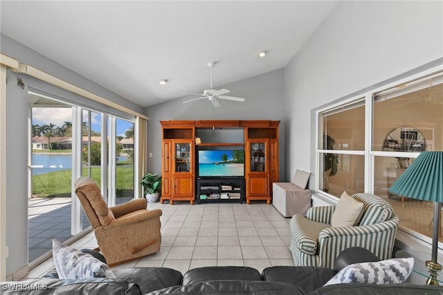 living area featuring ceiling fan, vaulted ceiling, and light tile patterned floors