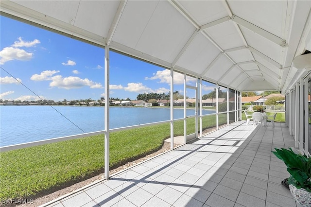 unfurnished sunroom with a water view and lofted ceiling