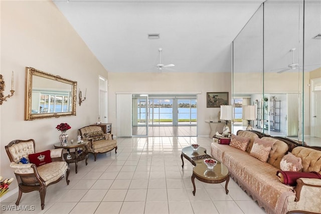 living area with high vaulted ceiling, tile patterned flooring, visible vents, and a ceiling fan