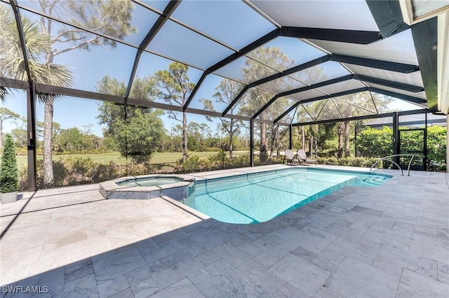 view of pool featuring a lanai, a pool with connected hot tub, and a patio