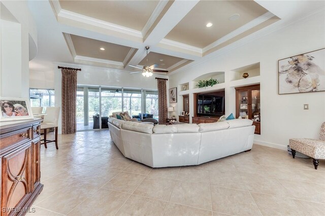 living room with ornamental molding, coffered ceiling, a towering ceiling, and a healthy amount of sunlight