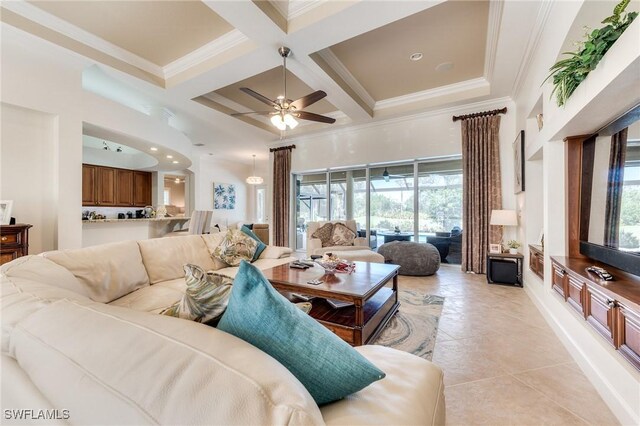 living area featuring ornamental molding, coffered ceiling, beamed ceiling, and a high ceiling