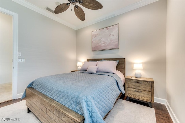 bedroom with ornamental molding, a ceiling fan, baseboards, and wood finished floors