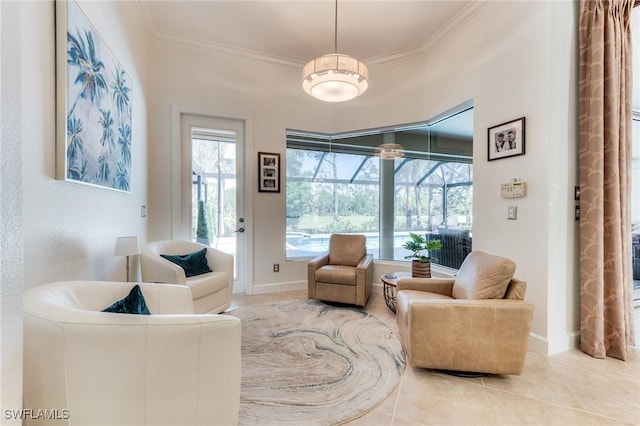 living area featuring ornamental molding, a sunroom, baseboards, and tile patterned floors