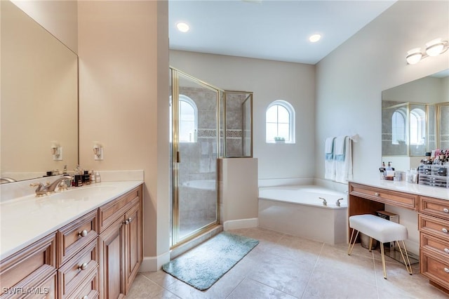 bathroom featuring a garden tub, a shower stall, vanity, tile patterned flooring, and baseboards