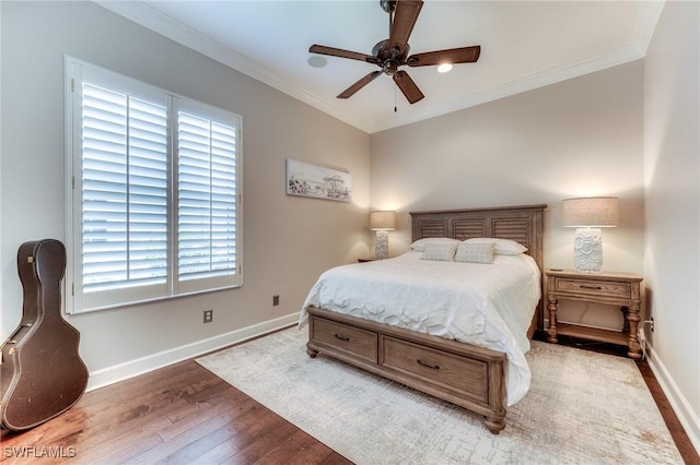 bedroom with baseboards, ornamental molding, and wood finished floors