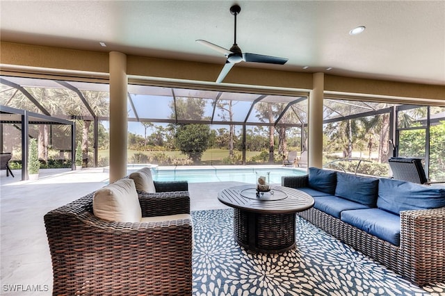 view of patio / terrace featuring a ceiling fan, a lanai, an outdoor pool, and an outdoor living space