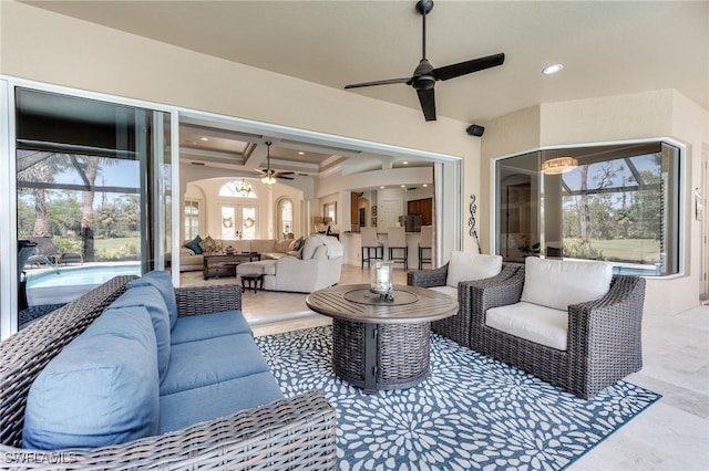 view of patio with an outdoor pool, an outdoor living space, and a ceiling fan