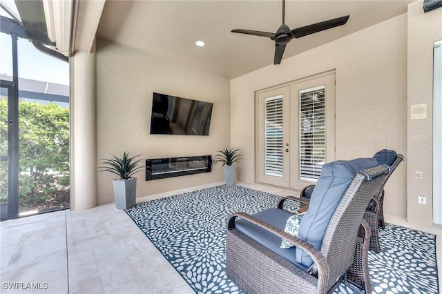 view of patio with glass enclosure, ceiling fan, and french doors