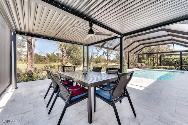 view of patio featuring outdoor dining space, a lanai, a ceiling fan, and an outdoor pool