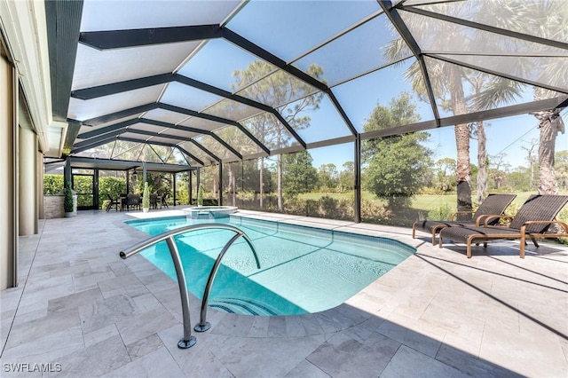 view of pool with a pool with connected hot tub, a patio, and a lanai