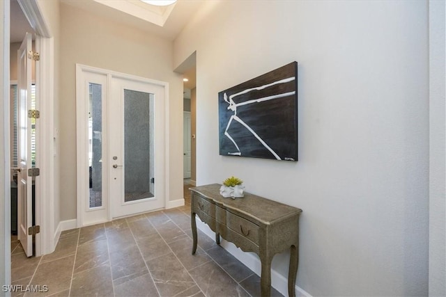 entryway featuring a skylight and baseboards