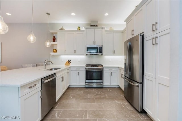 kitchen featuring a sink, backsplash, a peninsula, stainless steel appliances, and open shelves