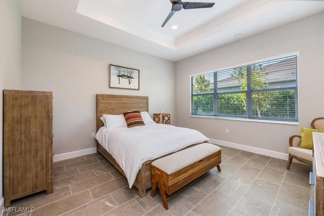 bedroom with recessed lighting, ceiling fan, baseboards, and a tray ceiling