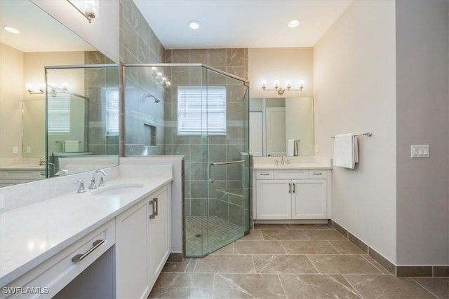 full bathroom with two vanities, a stall shower, and a sink