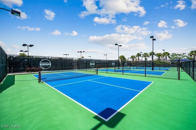 view of sport court featuring fence