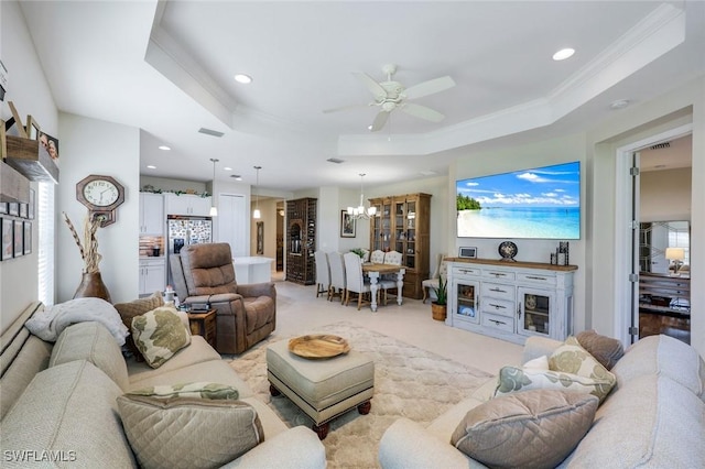 living room with recessed lighting, visible vents, a raised ceiling, and ornamental molding