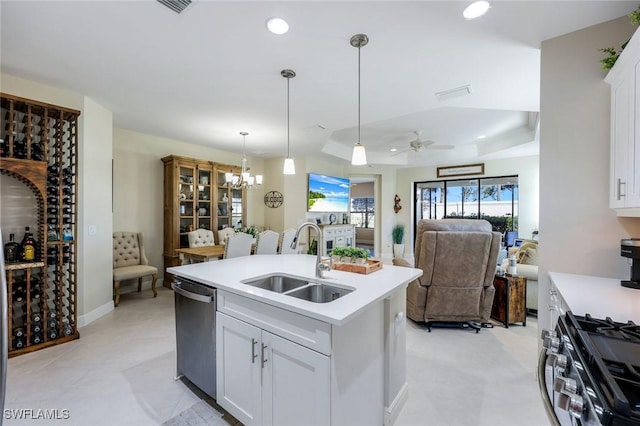 kitchen with a sink, light countertops, recessed lighting, appliances with stainless steel finishes, and a kitchen island with sink