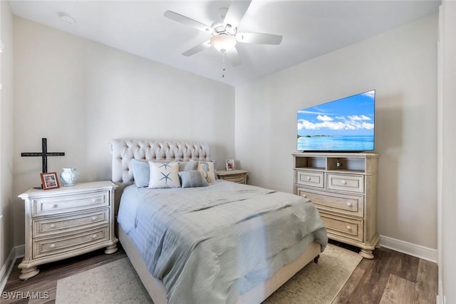 bedroom with baseboards, wood finished floors, and a ceiling fan