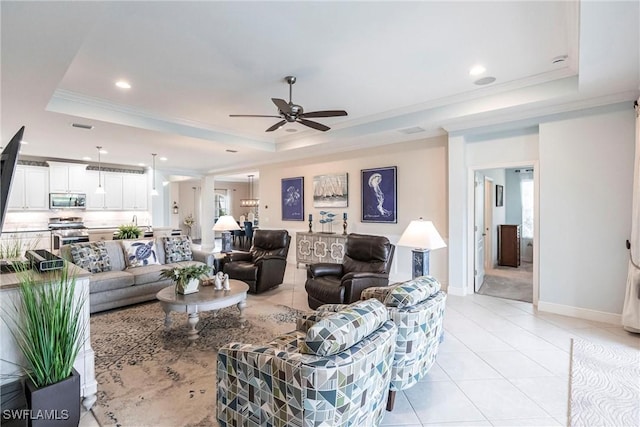 living area featuring baseboards, a raised ceiling, ornamental molding, light tile patterned flooring, and recessed lighting