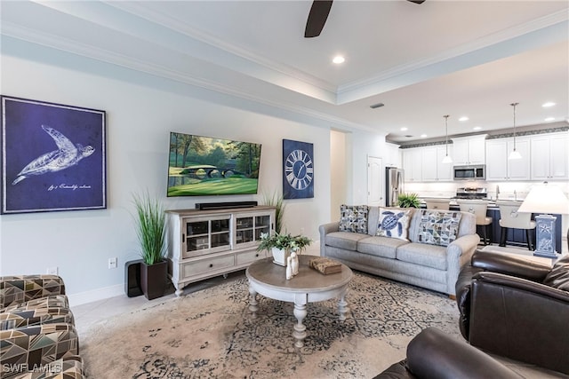 tiled living room featuring baseboards, ceiling fan, ornamental molding, a tray ceiling, and recessed lighting