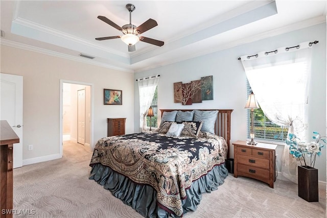 bedroom with light carpet, a tray ceiling, ornamental molding, and visible vents