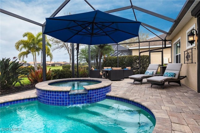 view of pool featuring a pool with connected hot tub, glass enclosure, a patio, and an outdoor hangout area