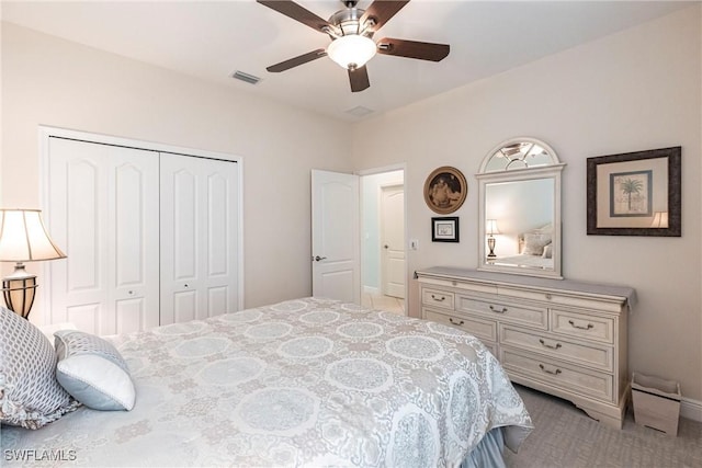 bedroom with a closet, visible vents, carpet flooring, ceiling fan, and baseboards