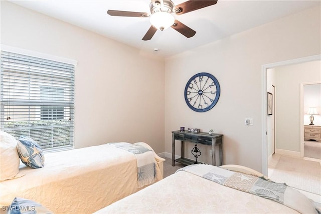 bedroom featuring baseboards, a ceiling fan, and carpet flooring