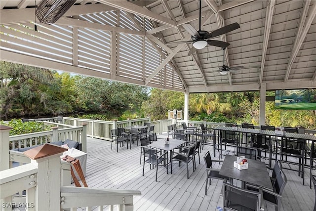 wooden deck with ceiling fan and outdoor dining space