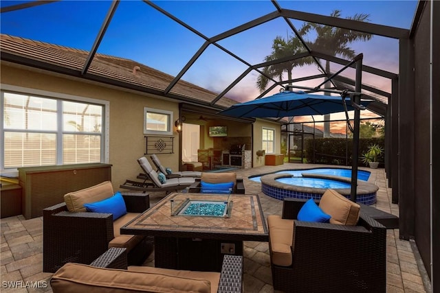 view of patio / terrace featuring an outdoor living space with a fire pit, a pool with connected hot tub, and a lanai