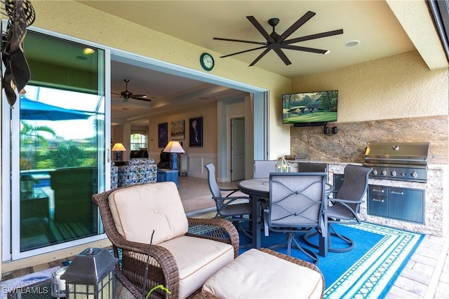 view of patio featuring ceiling fan, an outdoor kitchen, outdoor dining space, and area for grilling