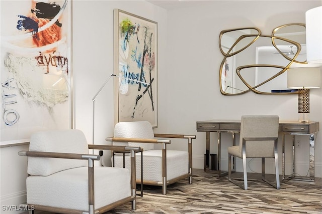 sitting room featuring baseboards and wood finished floors