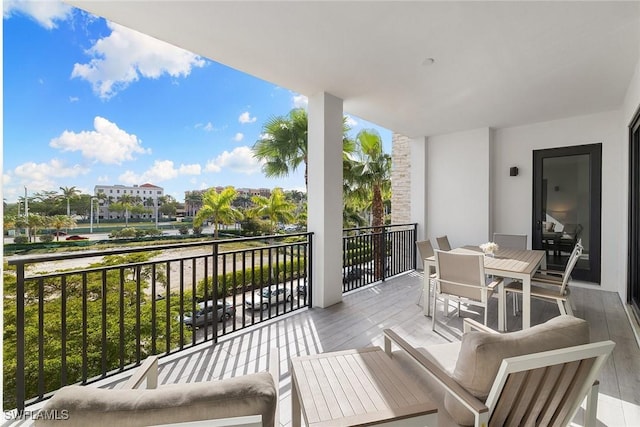 balcony with outdoor dining area and an outdoor hangout area