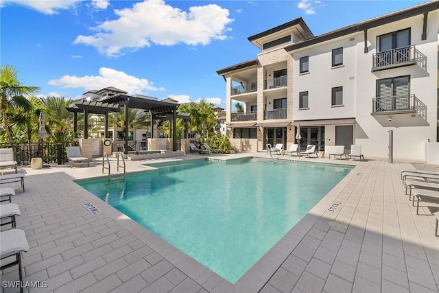 pool featuring fence, a patio area, and a pergola