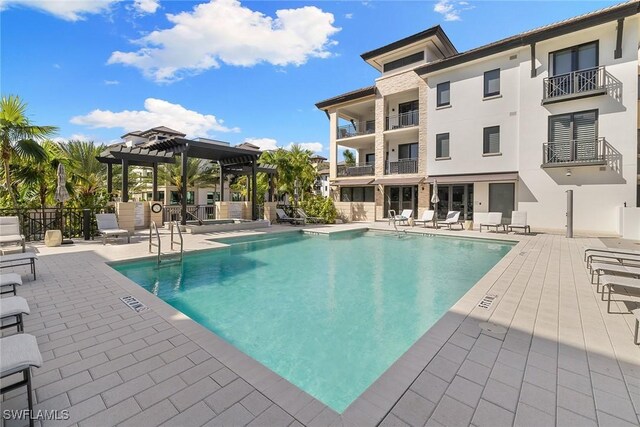 1135 3rd Ave S Unit 317, Naples, FL 34102 - community pool with a pergola, a patio, and fence