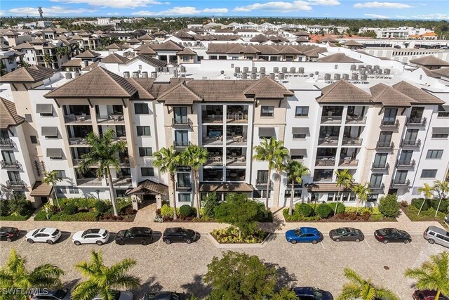 1135 3rd Ave S Unit 317, Naples, FL 34102 - view of apartment building / complex featuring uncovered parking