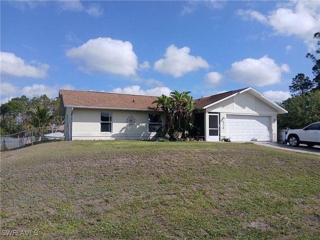 ranch-style home with a garage, fence, concrete driveway, and a front yard