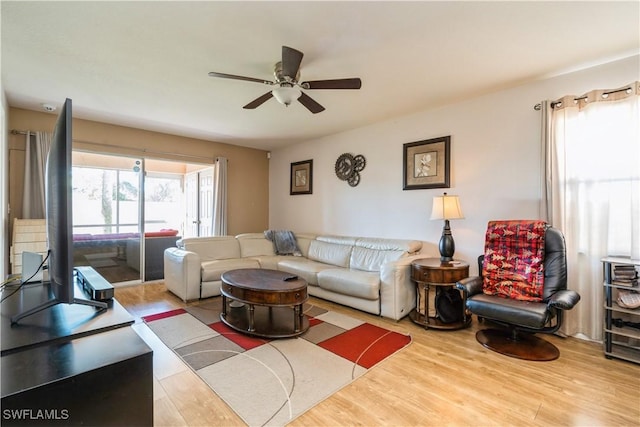 living area with ceiling fan and wood finished floors