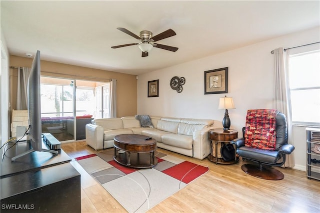 living area featuring a ceiling fan and wood finished floors